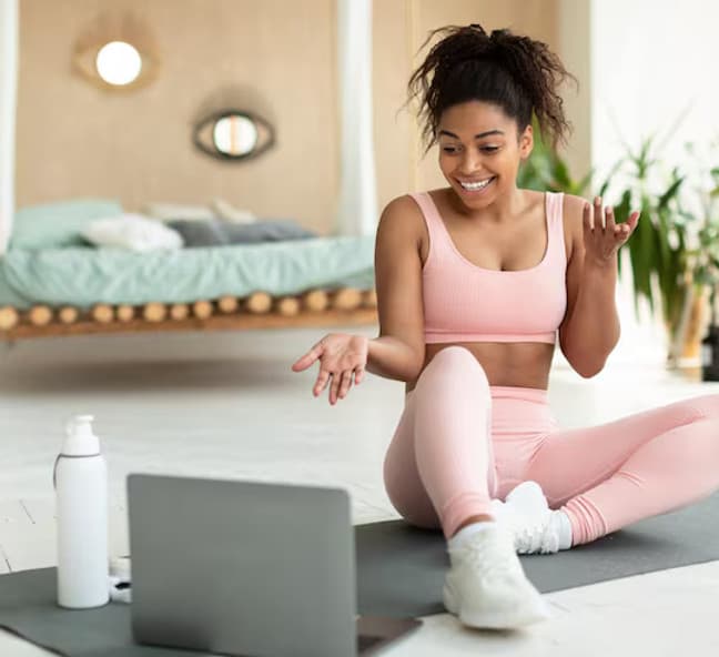 Client doing an exercise session at home guided by an online coach