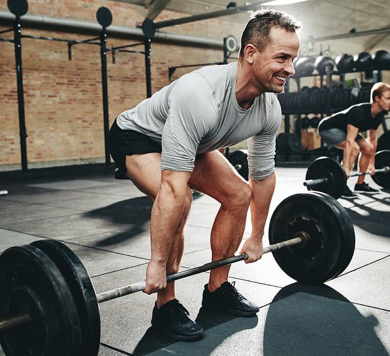 Athlete training in a well-equipped gym with strength and conditioning equipment